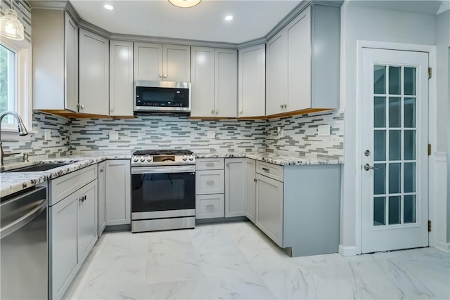 138 Cherry Rd, Rochester, NY 14612 - kitchen with appliances with stainless steel finishes, light marble finish floors, gray cabinets, light stone counters, and recessed lighting