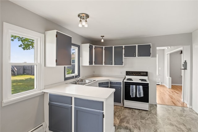 5808 W Wautoma Beach Rd, Hamlin, NY 14468 - kitchen with white electric range oven, healthy amount of natural light, baseboard heating, and light countertops