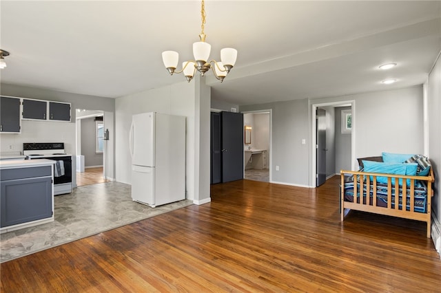 5808 W Wautoma Beach Rd, Hamlin, NY 14468 - kitchen with white appliances, a chandelier, light countertops, wood finished floors, and pendant lighting