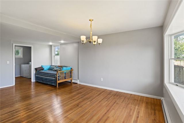 5808 W Wautoma Beach Rd, Hamlin, NY 14468 - spare room with a baseboard heating unit, a chandelier, wood finished floors, and washer / clothes dryer