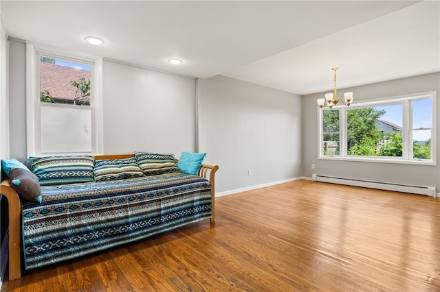 5808 W Wautoma Beach Rd, Hamlin, NY 14468 - bedroom featuring baseboard heating, a chandelier, and wood finished floors