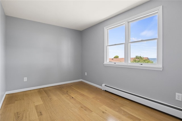 5808 W Wautoma Beach Rd, Hamlin, NY 14468 - unfurnished room featuring a baseboard heating unit and light wood finished floors