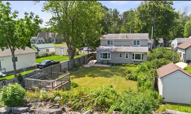 5808 W Wautoma Beach Rd, Hamlin, NY 14468 - rear view of house with a storage shed, a fenced backyard, a wooden deck, and a residential view