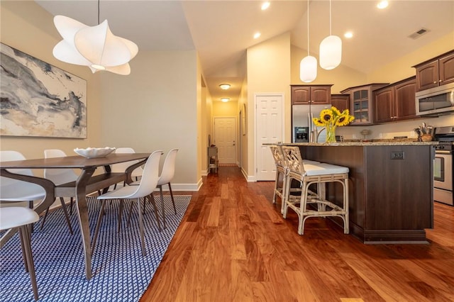246 Maryview Dr, Penfield, NY 14580 - dining area featuring dark wood-style floors, high vaulted ceiling, and recessed lighting