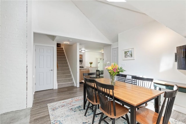 1848 Otisco Valley Rd, Otisco, NY 13110 - dining room with stairway, high vaulted ceiling, and wood finished floors