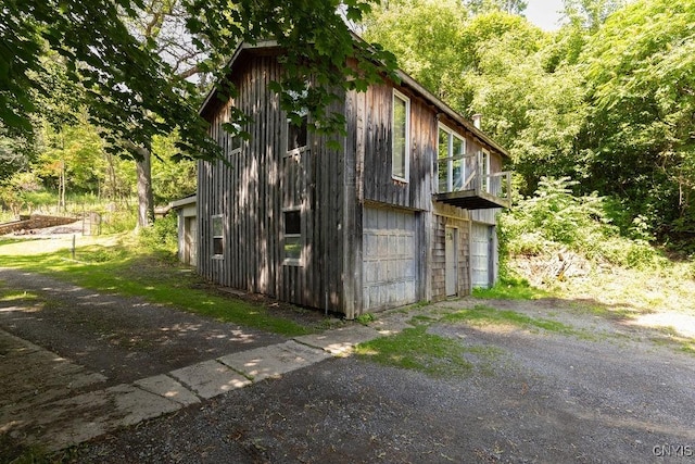 1848 Otisco Valley Rd, Otisco, NY 13110 - view of outdoor structure featuring asphalt driveway and a forest view