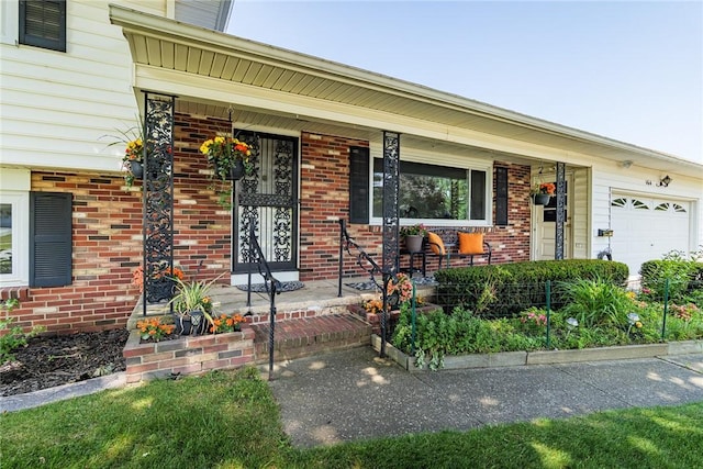 164 Queens Ln, Irondequoit, NY 14617 - property entrance featuring a garage, covered porch, and brick siding