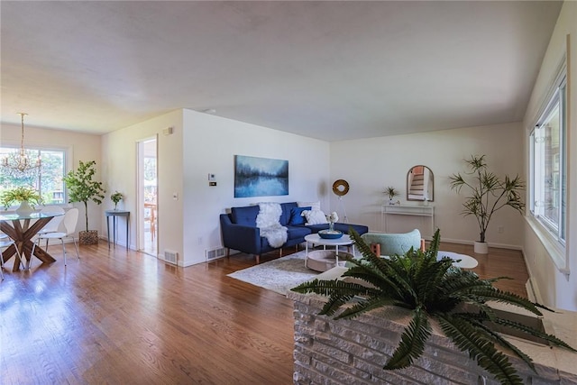 164 Queens Ln, Irondequoit, NY 14617 - living area featuring wood finished floors and a chandelier