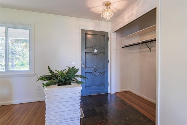 164 Queens Ln, Irondequoit, NY 14617 - entryway featuring baseboards and a chandelier