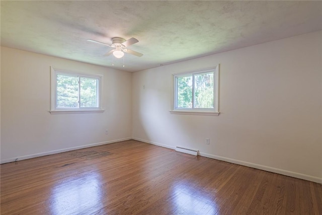 164 Queens Ln, Irondequoit, NY 14617 - empty room with plenty of natural light, ceiling fan, and wood finished floors