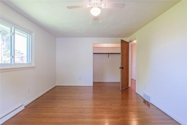 164 Queens Ln, Irondequoit, NY 14617 - unfurnished bedroom with baseboard heating, light wood finished floors, a closet, and ceiling fan
