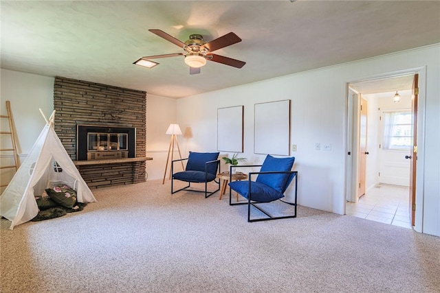 164 Queens Ln, Irondequoit, NY 14617 - living area with ceiling fan, carpet flooring, a stone fireplace, and ornamental molding