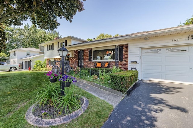 164 Queens Ln, Irondequoit, NY 14617 - split level home with brick siding, a front yard, a garage, driveway, and covered porch