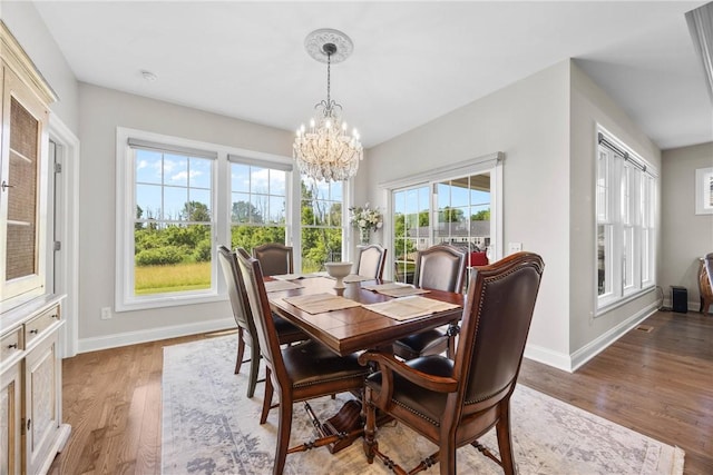 905 Pathway Ln, Webster, NY 14580 - dining area with a chandelier and light wood-type flooring
