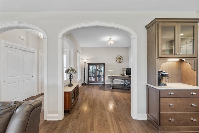 905 Pathway Ln, Webster, NY 14580 - hall with arched walkways, dark wood-style flooring, and an office area