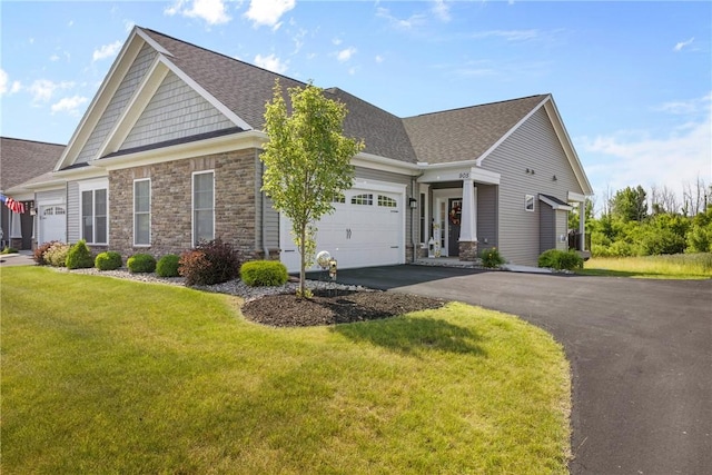 905 Pathway Ln, Webster, NY 14580 - craftsman-style home with a garage, stone siding, asphalt driveway, and a front lawn