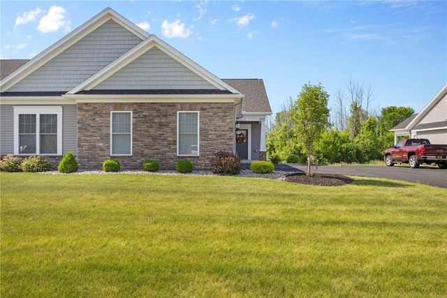 905 Pathway Ln, Webster, NY 14580 - craftsman house featuring a front lawn and stone siding
