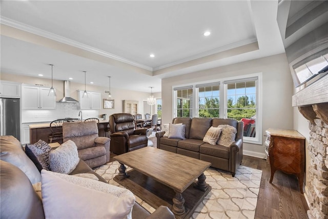 905 Pathway Ln, Webster, NY 14580 - living area with light wood-style flooring, a raised ceiling, a chandelier, recessed lighting, and ornamental molding