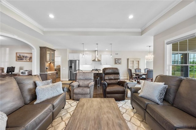 905 Pathway Ln, Webster, NY 14580 - living area featuring a raised ceiling, recessed lighting, a chandelier, crown molding, and arched walkways