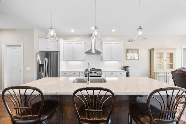 905 Pathway Ln, Webster, NY 14580 - kitchen featuring appliances with stainless steel finishes, an island with sink, wood finished floors, backsplash, and recessed lighting