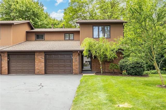 321 Penhurst Rd, Brighton, NY 14610 - view of front of home featuring a front yard, asphalt driveway, a shingled roof, and brick siding