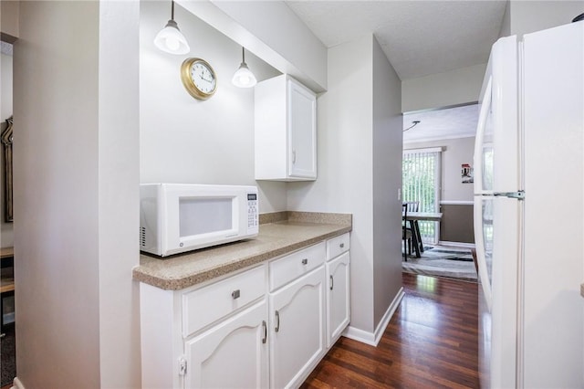 321 Penhurst Rd, Brighton, NY 14610 - kitchen with white appliances, dark wood finished floors, white cabinets, and light countertops