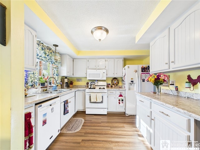 407 N Clark St, Olean, NY 14760 - kitchen featuring white appliances, light countertops, wood finished floors, a textured ceiling, and white cabinets