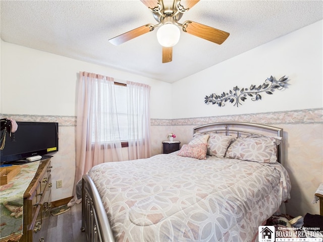 407 N Clark St, Olean, NY 14760 - bedroom with wood finished floors, a wainscoted wall, ceiling fan, and a textured ceiling