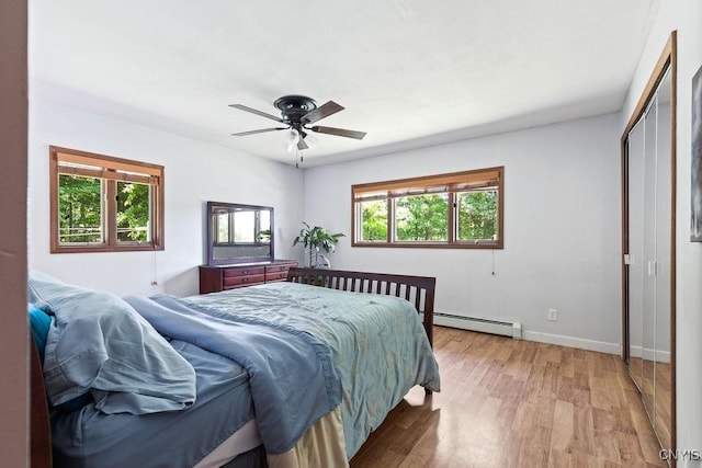 20 Hickory Grove Rd, Spur, Minetto, NY 13069 - bedroom with a baseboard heating unit, light wood-style flooring, and ceiling fan