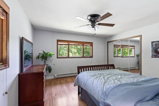 20 Hickory Grove Rd, Spur, Minetto, NY 13069 - bedroom featuring baseboard heating, wood finished floors, a closet, and a ceiling fan