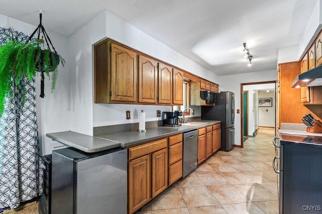 20 Hickory Grove Rd, Spur, Minetto, NY 13069 - kitchen with stainless steel appliances, brown cabinets, track lighting, and dark countertops