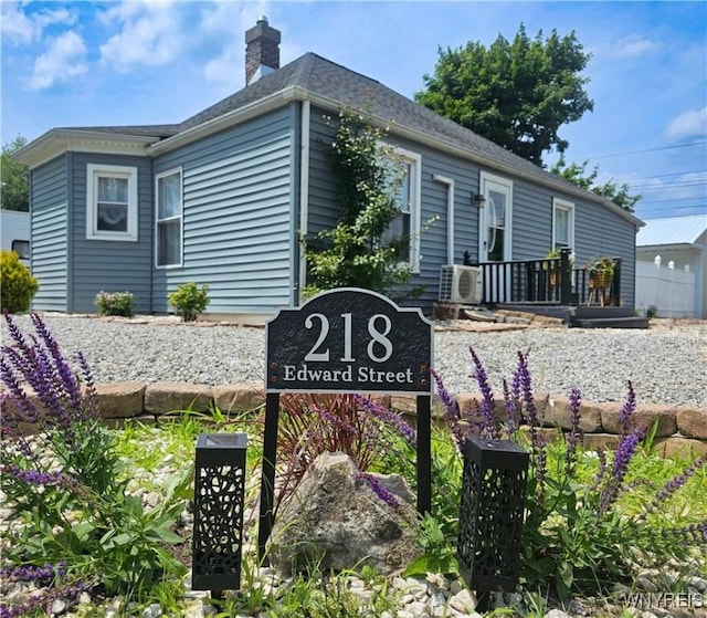 218 Edward St, North Tonawanda, NY 14120 - exterior view of a chimney, a downspout, and roof with shingles