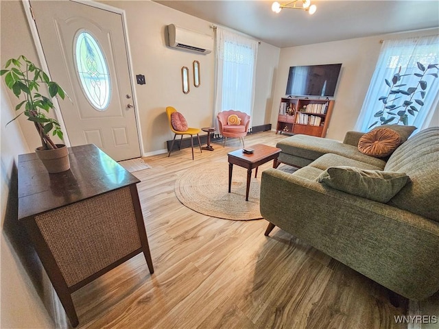 218 Edward St, North Tonawanda, NY 14120 - living room with a wall mounted AC and light wood finished floors
