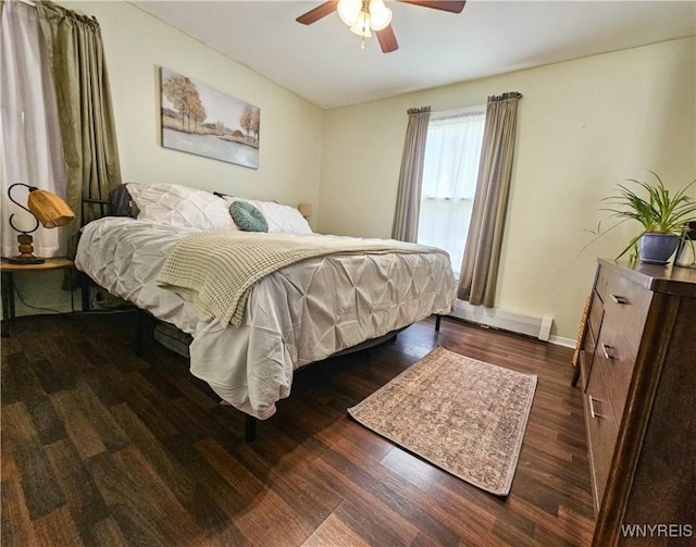 218 Edward St, North Tonawanda, NY 14120 - bedroom featuring wood finished floors, a baseboard radiator, and a ceiling fan