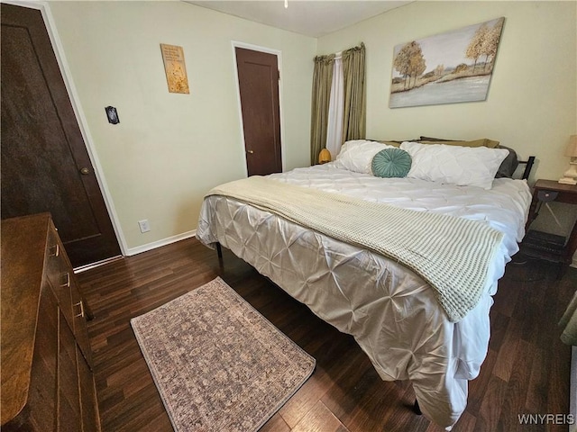 218 Edward St, North Tonawanda, NY 14120 - bedroom with baseboards and dark wood-type flooring