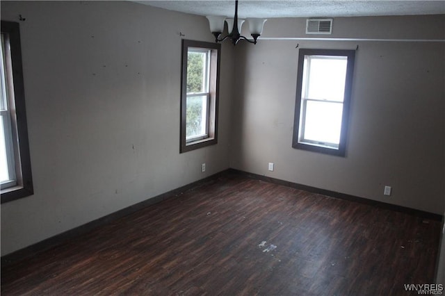 61 N Franklin St, New Albion, NY 14719 - empty room with dark wood-style flooring, a chandelier, and a textured ceiling