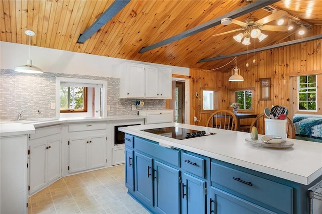 1753 Log Cabin Rd, Torrey, NY 14527 - kitchen with black electric cooktop, blue cabinetry, decorative backsplash, wood ceiling, and white cabinets