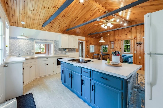 1753 Log Cabin Rd, Torrey, NY 14527 - kitchen with freestanding refrigerator, blue cabinets, black electric cooktop, wooden ceiling, and backsplash
