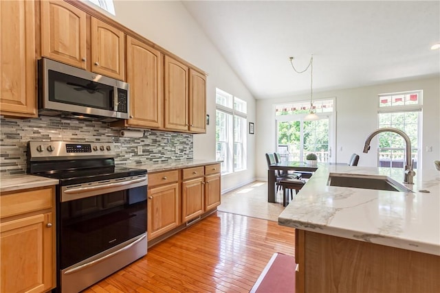 801 Surrey Hill Way, Henrietta, NY 14623 - kitchen with appliances with stainless steel finishes, tasteful backsplash, healthy amount of natural light, lofted ceiling, and light wood-style flooring