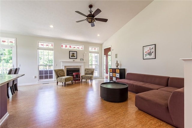 801 Surrey Hill Way, Henrietta, NY 14623 - living area featuring a glass covered fireplace, healthy amount of natural light, ceiling fan, wood finished floors, and recessed lighting