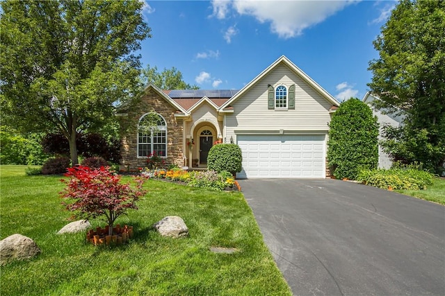 801 Surrey Hill Way, Henrietta, NY 14623 - traditional-style home with asphalt driveway, solar panels, a garage, stone siding, and a front lawn