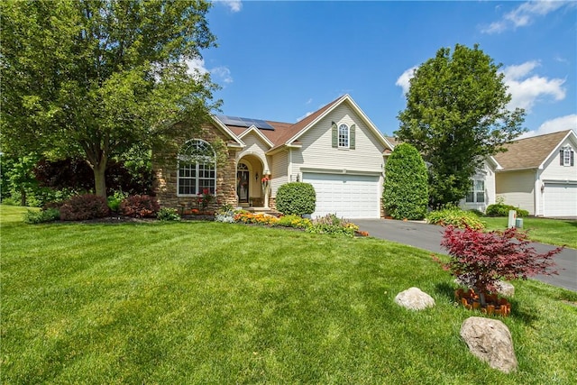 801 Surrey Hill Way, Henrietta, NY 14623 - view of front of home featuring solar panels, a front yard, driveway, and a garage