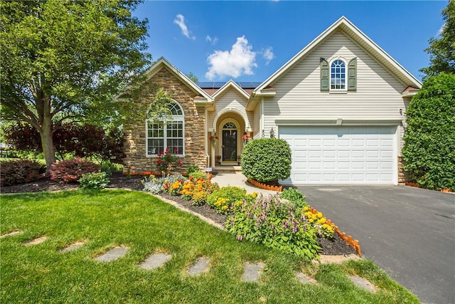 801 Surrey Hill Way, Henrietta, NY 14623 - traditional home featuring driveway, stone siding, an attached garage, solar panels, and a front lawn