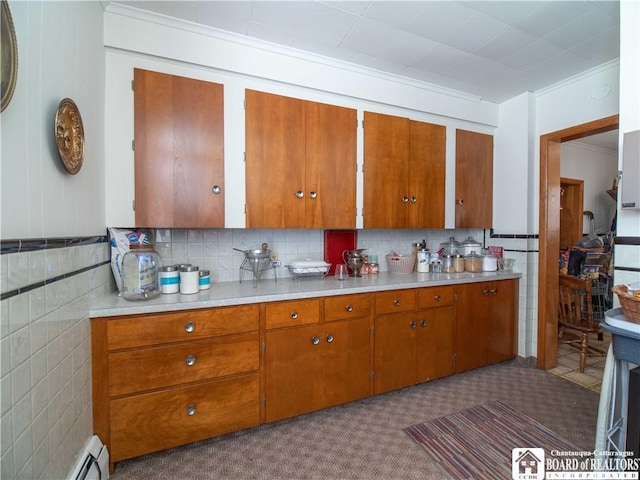 12 Central Ave, Portland, NY 14716 - kitchen with brown cabinets, light countertops, tile walls, and ornamental molding