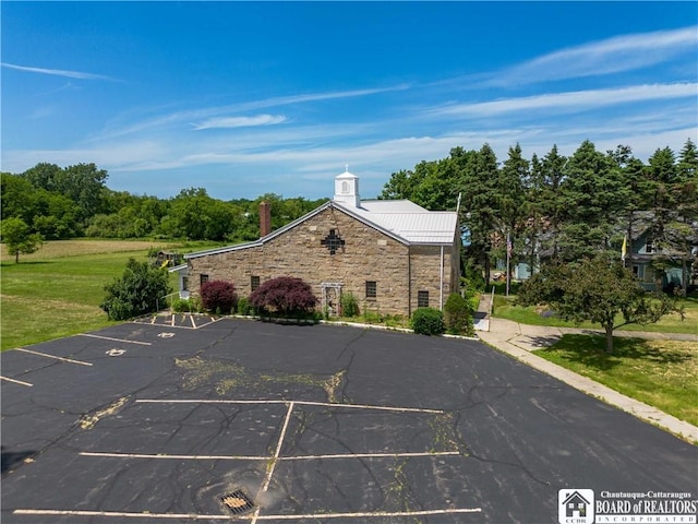 12 Central Ave, Portland, NY 14716 - view of front of home featuring stone siding, uncovered parking, and a chimney