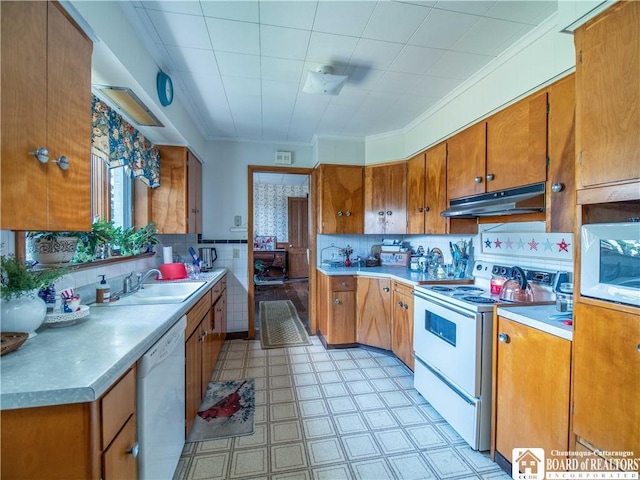 12 Central Ave, Portland, NY 14716 - kitchen with white appliances, under cabinet range hood, brown cabinetry, light countertops, and light flooring