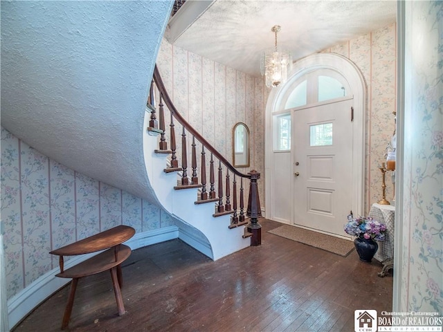 12 Central Ave, Portland, NY 14716 - entrance foyer with wallpapered walls, hardwood / wood-style floors, a chandelier, stairway, and a textured ceiling