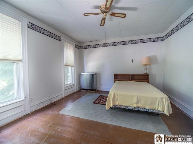 12 Central Ave, Portland, NY 14716 - bedroom featuring radiator, hardwood / wood-style floors, and ceiling fan