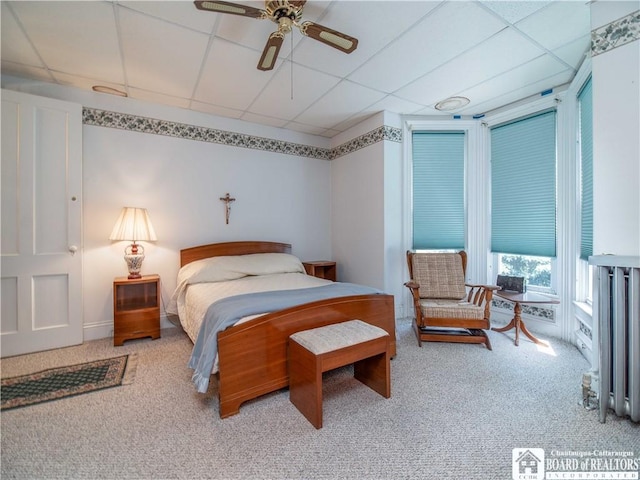 12 Central Ave, Portland, NY 14716 - bedroom with carpet floors, a paneled ceiling, radiator, and ceiling fan