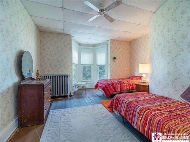 12 Central Ave, Portland, NY 14716 - bedroom with hardwood / wood-style flooring, wallpapered walls, radiator, and a drop ceiling